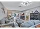 Comfortable living room boasting gray sofas, modern décor, and sliding glass doors to backyard at 900 Maclaren N Dr # D, Palm Harbor, FL 34684