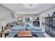 Cozy living room with gray sofa, decorative pillows, view of waterfront, and modern ceiling fixture at 900 Maclaren N Dr # D, Palm Harbor, FL 34684