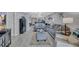 Spacious open living area featuring light gray sofas, modern decor, and light gray flooring at 900 Maclaren N Dr # D, Palm Harbor, FL 34684