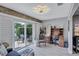 Bright home office features natural light, wood floors, sliding glass doors, and modern lighting at 900 Maclaren N Dr # D, Palm Harbor, FL 34684