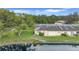 Scenic view of a villa near the water with lush lawns and serene surroundings at 900 Maclaren N Dr # D, Palm Harbor, FL 34684
