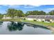 Villa overlooking a tranquil pond with manicured lawn and relaxing patio space at 900 Maclaren N Dr # D, Palm Harbor, FL 34684