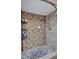 Close-up of stylish tiled shower with decorative wall and stone floor at 900 Maclaren N Dr # D, Palm Harbor, FL 34684