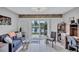 Cozy sitting area with comfortable sofa, tile floors, shutters, and view of waterfront at 900 Maclaren N Dr # D, Palm Harbor, FL 34684