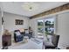 Inviting sitting area features a comfortable blue sofa, white shutters, and water views at 900 Maclaren N Dr # D, Palm Harbor, FL 34684