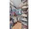 Spacious walk-in closet with ample hanging space and shelving for optimal organization and storage at 900 Maclaren N Dr # D, Palm Harbor, FL 34684