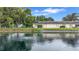 Villa situated by a beautiful pond with lush green lawns and mature trees at 900 Maclaren N Dr # D, Palm Harbor, FL 34684