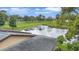 Scenic pond view near a golf course from villa, with lush green surroundings at 900 Maclaren N Dr # D, Palm Harbor, FL 34684