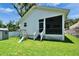Spacious backyard with a swing set, lawn and screened in porch at 910 E Crenshaw St, Tampa, FL 33604