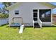 Backyard featuring a swing set, slide, and screened porch at 910 E Crenshaw St, Tampa, FL 33604