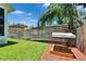 Lush backyard with a wood fence, sandbox and green lawn at 910 E Crenshaw St, Tampa, FL 33604