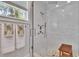 The glass shower has a showerhead, a rain shower, and river rock flooring inside of the shower at 910 E Crenshaw St, Tampa, FL 33604