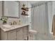 Well-lit bathroom featuring a marble countertop vanity and a shower and tub combination at 910 E Crenshaw St, Tampa, FL 33604