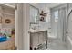 Well-lit bathroom featuring a marble countertop vanity and a shower and tub combination at 910 E Crenshaw St, Tampa, FL 33604