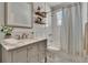 Well-lit bathroom featuring a marble countertop vanity and a shower and tub combination at 910 E Crenshaw St, Tampa, FL 33604