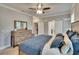 This bedroom showcases a wooden dresser, a large mirror, a ceiling fan, and a walk-in closet at 910 E Crenshaw St, Tampa, FL 33604