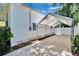 Covered carport or parking area providing shelter for vehicles, next to a white fenced yard at 910 E Crenshaw St, Tampa, FL 33604