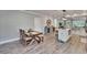 Open-concept dining area next to the kitchen, with wooden table and plenty of natural light at 910 E Crenshaw St, Tampa, FL 33604