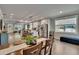 Spacious dining room showing wood table and a full view to an open-concept kitchen at 910 E Crenshaw St, Tampa, FL 33604