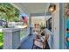 Front porch with rocking chairs, plants, and American flag at 910 E Crenshaw St, Tampa, FL 33604
