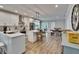 Bright kitchen with white cabinetry, stainless steel appliances, a center island and dining area at 910 E Crenshaw St, Tampa, FL 33604