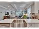 Bright kitchen featuring a stainless steel sink and open view to the living area at 910 E Crenshaw St, Tampa, FL 33604