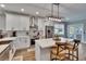 Chic kitchen with island seating, stainless steel appliances, and white cabinets at 910 E Crenshaw St, Tampa, FL 33604