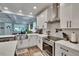 Modern kitchen with stainless steel appliances, white cabinets, and sleek countertops at 910 E Crenshaw St, Tampa, FL 33604