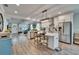 Open-concept kitchen with stainless steel appliances, a large island, and direct sightlines to the living area at 910 E Crenshaw St, Tampa, FL 33604