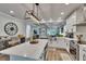 Bright kitchen features an island with seating, stainless steel appliances, and white cabinetry at 910 E Crenshaw St, Tampa, FL 33604