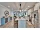 Open kitchen with stainless steel appliances, white cabinets, and island seating at 910 E Crenshaw St, Tampa, FL 33604