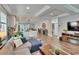 Spacious living room with modern furnishings, recessed lighting, and seamless open floorplan to kitchen at 910 E Crenshaw St, Tampa, FL 33604