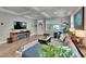 Bright living room with open floorplan, providing a modern aesthetic, and seamless open floorplan to kitchen at 910 E Crenshaw St, Tampa, FL 33604