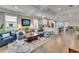 Open-concept living room with hardwood floors, recessed lighting, and a seamless transition to the modern kitchen at 910 E Crenshaw St, Tampa, FL 33604