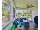 Spacious screened porch with dark wood floors, fan, grill, and comfortable seating at 910 E Crenshaw St, Tampa, FL 33604