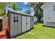 Backyard shed with double doors and windows for ample storage space at 910 E Crenshaw St, Tampa, FL 33604