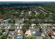 Aerial view of the neighborhood with tree-lined streets, homes, and swimming pools at 9951 121St St, Seminole, FL 33772