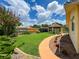 Beautiful backyard with a gazebo, green grass, flowerbeds, and a walkway at 9951 121St St, Seminole, FL 33772