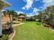 Expansive backyard features a well-manicured lawn, lush landscaping, and a charming gazebo at 9951 121St St, Seminole, FL 33772