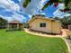 Exterior view of the home, landscaped yard, and gazebo in the backyard at 9951 121St St, Seminole, FL 33772