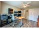 Bedroom with ceiling fan, featuring wood-look flooring, multiple computer monitors, and closet at 9951 121St St, Seminole, FL 33772