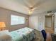 Cozy bedroom with wood-look floors, a ceiling fan, and natural light from a window at 9951 121St St, Seminole, FL 33772
