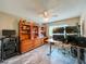 Spacious bedroom featuring wood-look flooring and a large built-in cabinet with display shelving at 9951 121St St, Seminole, FL 33772