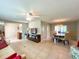 Open-concept living and dining area with tile floors, ceiling fan, and a round wooden dining table at 9951 121St St, Seminole, FL 33772