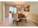 Dining area with tile flooring, a wooden table with upholstered chairs, and sliding glass doors to the outside at 9951 121St St, Seminole, FL 33772