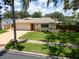 Inviting single-story home featuring a well-manicured lawn and tile roof at 9951 121St St, Seminole, FL 33772