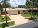 Charming single-story home featuring a well-manicured lawn and neutral color palette at 9951 121St St, Seminole, FL 33772