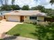 Charming single-story home with a well-manicured lawn, tiled roof, and attached garage, offering great curb appeal at 9951 121St St, Seminole, FL 33772