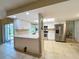 Bright kitchen features white cabinets, stainless steel appliances, and breakfast bar for casual dining at 9951 121St St, Seminole, FL 33772