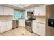 Updated kitchen features stainless steel appliances and stone backsplash at 9951 121St St, Seminole, FL 33772